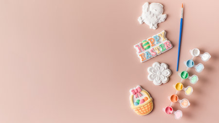 Easter figures made of plaster with paints, the concept of childrens crafts for Easter. Copy space