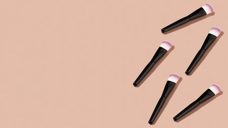 Cosmetic makeup brushes on a pink background with a baby shadow. Make-up. Copy space