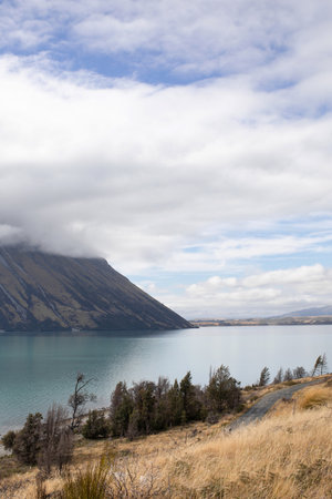 Landscape of a mountain lake, road, mountains. Beautiful landscape of New Zealandの写真素材