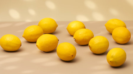 A handful of yellow ripe lemons on a beige background with a shadow pattern.の写真素材