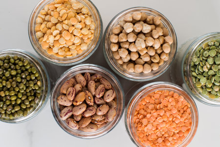 Legumes in glass jars top view. Vegetable protein, vegetarianism, healthy eatingの写真素材