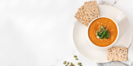 A mug of warm pumpkin soup. The concept of the autumn menu. Autumn recipes. Copy spaceの写真素材