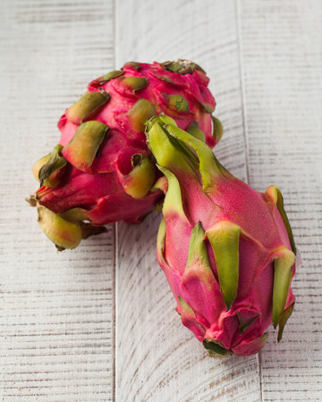 Dragon fruit on a light wooden background. Tropical fruits.の写真素材