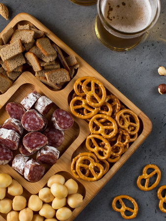 Wooden menagerie with beer snacks. A plate with assorted sausages, cheese, crackers.の写真素材