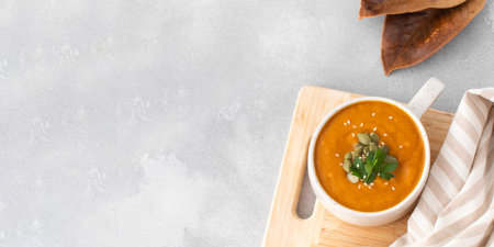 A mug of warm pumpkin soup. The concept of the autumn menu. Autumn recipes. Copy spaceの写真素材