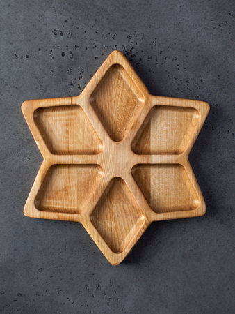An empty wooden menagerie in the shape of a star. Wooden dishes, a plate for serving snacks.の写真素材