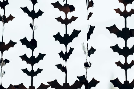 The window is decorated with decorative bats for Halloween. Home decor for Halloween.の写真素材