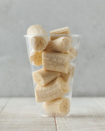 Slices of banana in a clear glass. Fruit salad, takeaway food.の写真素材