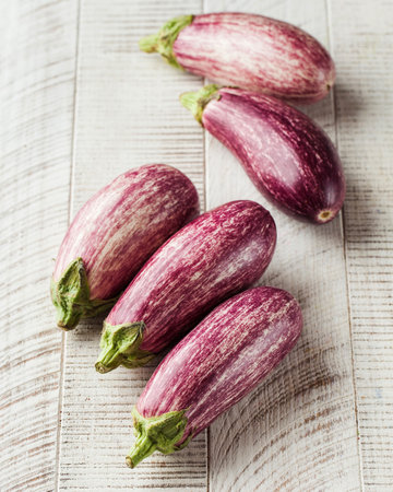 Pickled cucumbers in a wooden bowl on a white background. Vegetable preservation