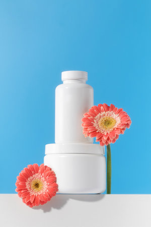 Mockup is a white jar with pills or vitamins on a podium. Vitamins for womenの写真素材