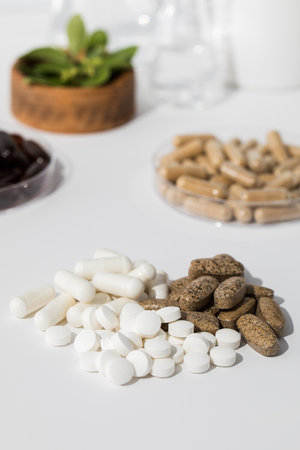 Various vitamins, tablets and dietary supplements with natural formulations on a white background.