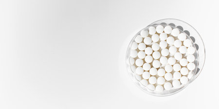 White round tablets on a white background. Tablets, minerals and vitamins. Copy space