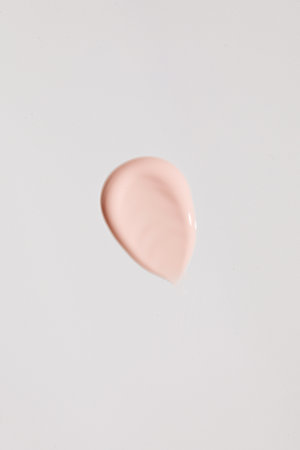 Swatch. The texture of a pink cosmetic product, cream on a white background. Sample of skin care cosmetics.の写真素材