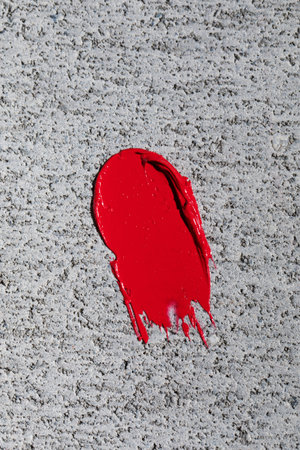 Swatch. A smear of red lipstick on a white. Texture of the cosmetic product.の写真素材