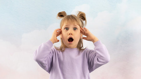 Stunned young lady clutches head in horror opening mouthの写真素材