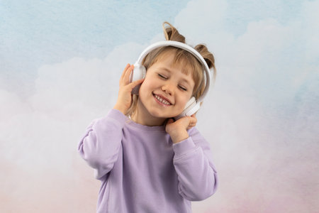 Junior schoolgirl enjoys listening to favorite music with smile