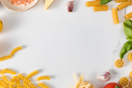 Frame of handmade pasta and cooking ingredients on tableの写真素材