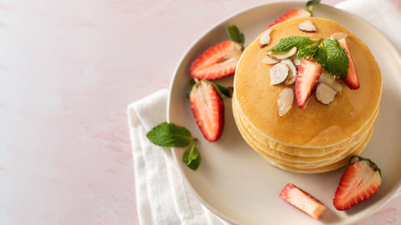 Homemade pancakes with strawberries and almonds a delightful, nutritious meal for a special treatの写真素材