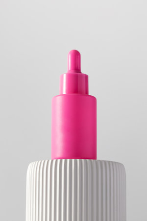 Pink dropper with anti-aging serum on the podium. Cosmetics, skin care.の写真素材