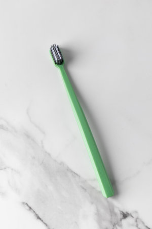 Eco friendly green brush on the marble table. Oral hygiene.の写真素材