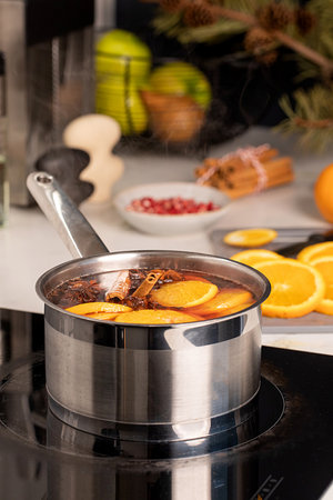 A pot of freshly made mulled wine on the stove in the kitchen.の写真素材