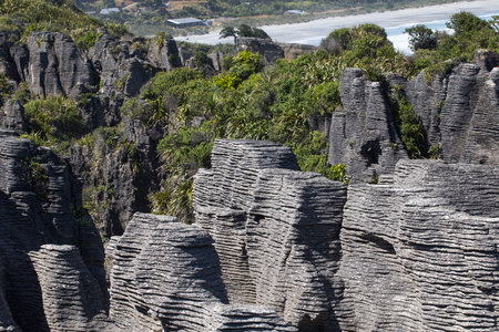 Stunning pancake rocks and lush greenery in new zealands punakaiki landscape.の写真素材