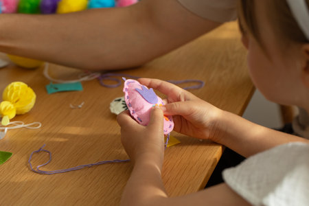 Dad helps daughter make a toy with her own hands. diyの写真素材