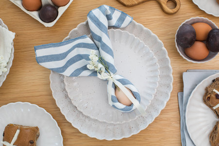 Easter egg wrapped in linen napkin in the shape of bunny with ears. Happy Easterの写真素材