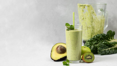 Fresh green smoothie with avocado, kiwi and spinach for healthy living and detox diet. Copy spaceの写真素材