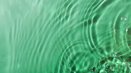 Abstract ripples and bubbles in green water surface for creative design
