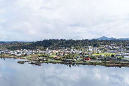 colorful homes beside tranquil water, quiet port town with lively houses and peaceful waterwaysの写真素材