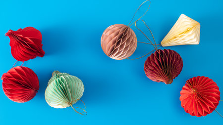 Bright paper decorations for the Christmas tree on a blue background. Christmas decorations.の写真素材