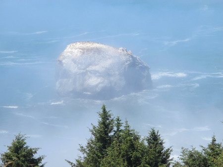 Rock Island Off the Foggy Shore of Pacific Northwestの写真素材