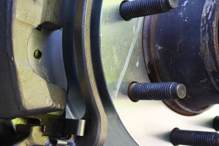 Bolts of a wheel hub with newly replaced caliper, rotor and brake padsの写真素材