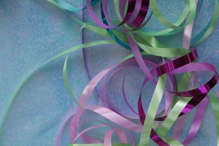 multi colored curly ribbons on teal background