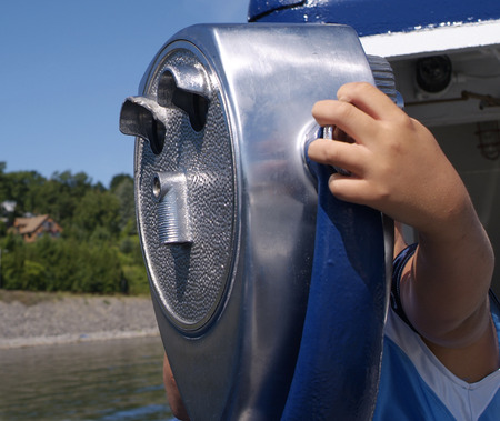 person looking through a tourist telescopeの写真素材