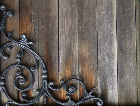 old stained wood with wrought iron designの写真素材