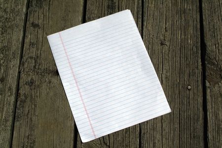 Rustic wooden background with notepaper.