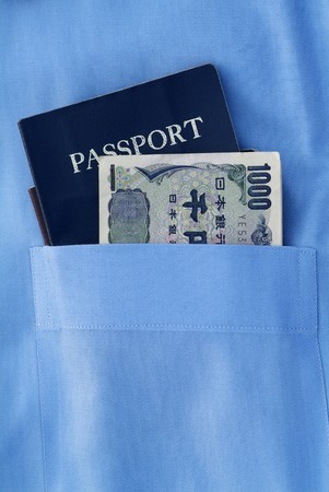 passport with japanese currency in the blue pocketの写真素材