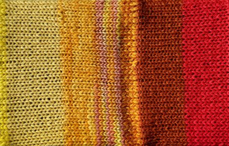 Bright warm colored red and yellow yarn crochet backgroundの写真素材
