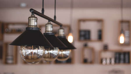 Luxury ceiling lamp decor in coffee shop. Vintage chandelier hanging from ceiling.の写真素材