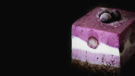 Delicious blueberry cheesecake on a black background. Selective focus.の写真素材