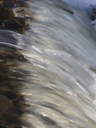 A small waterfall on a flooded creek.の写真素材