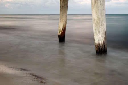 Jetty pylons on a stormy morning.の写真素材