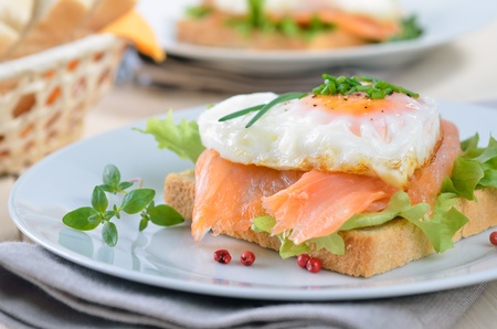 Toast with smoked salmon and heart shaped fried eggの写真素材