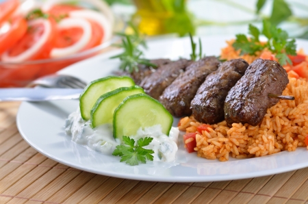 Grilled Greek meat balls with tzatziki and paprika riceの写真素材