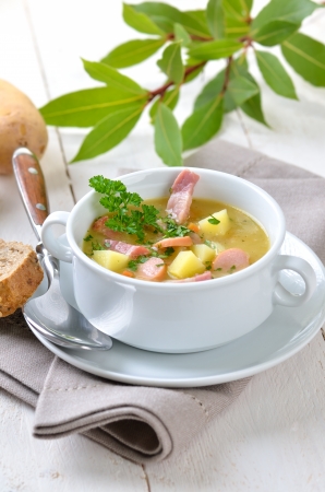 Freshly made potato soup with bacon strips and Vienna sausage wheelsの写真素材