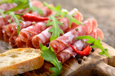 Italian salami from Tuscany served on a wooden boardの写真素材
