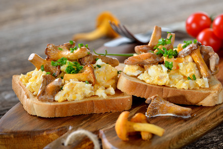 Scrambled eggs with chanterelles on toastの写真素材