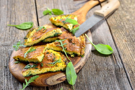 Cuts of delicious herb omelette with parmesan cheese
